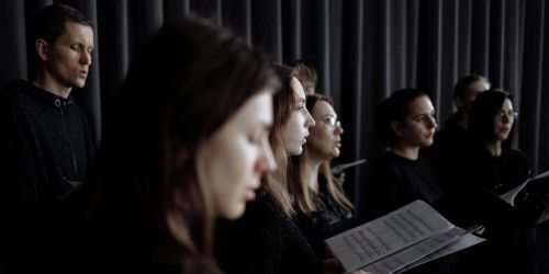 Coro composto da ragazze e ragazzi con spartiti