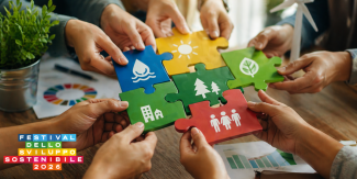 Immagine di mani che reggono pezzi di un puzzle in legno con i simboli di alcuni degli obiettivi dell'Agenda 20230. In basso a sinistra il logo del Festival dello Sviluppo Sostenibile 2026.