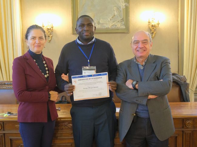 George Mbugua from Kenyatta University receive his certificate of attendance at the end of the staff week